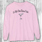 Pink long-sleeve margarita tee shirt with a graphic and text on a wooden surface
