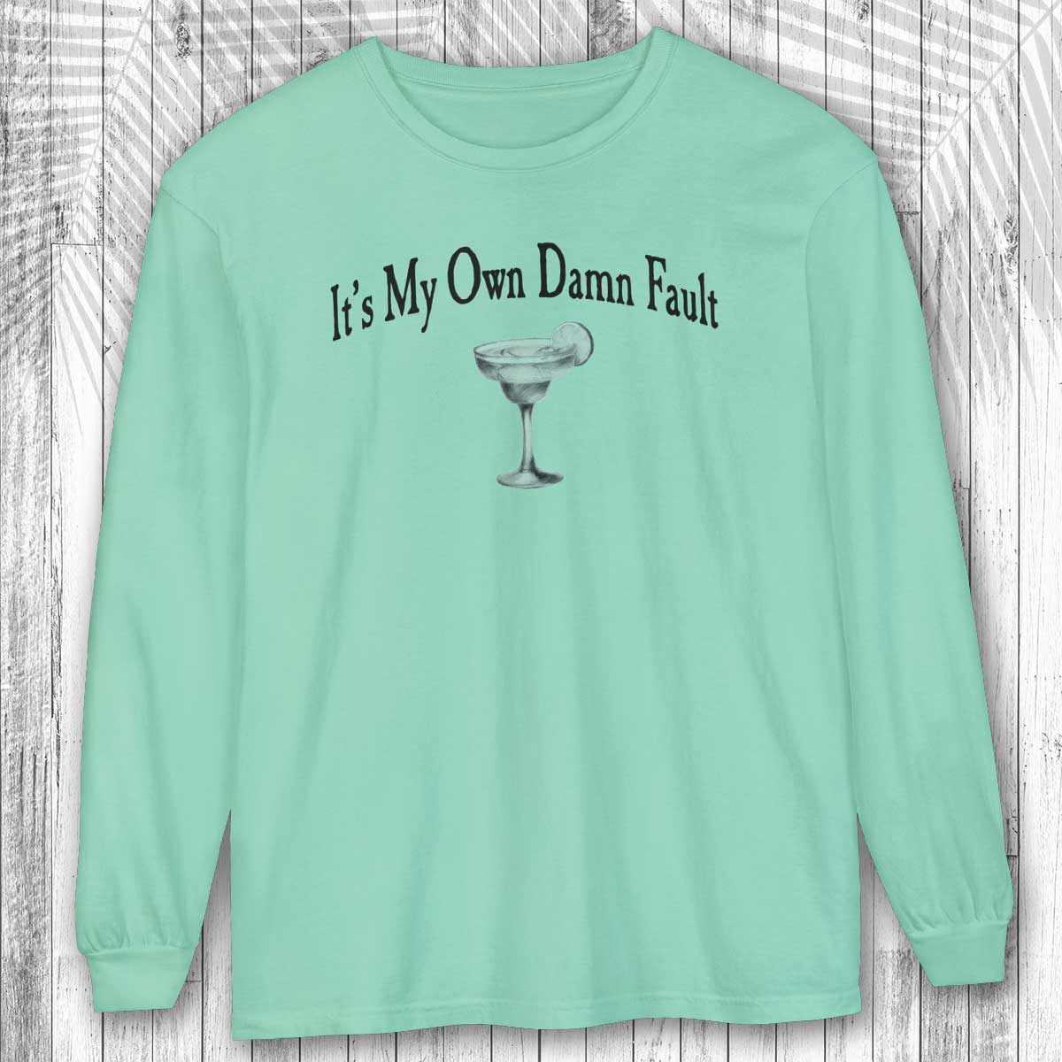 Island Reef green long-sleeve margarita tee shirt with a graphic and text on a wooden background
