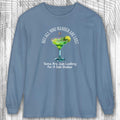 Blue long-sleeve shirt with a graphic of a margarita and text on a wooden background
