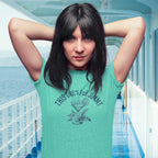 Woman wearing a teal t-shirt with text and graphic of Margarita and the words This One's For Jimmy, standing on the deck of a Margaritaville Cruise Ship