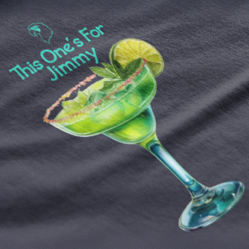 T-shirt with a margarita graphic and 'This One's For Jimmy' text on a dark fabric background