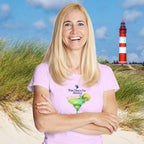 Woman wearing a pink t-shirt with a lighthouse and grass in the background