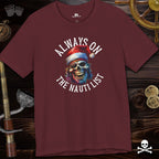 Maroon t-shirt with a skull wearing a Santa hat and text 'Always on the Nauti List' on a wooden background.
