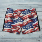 American flag patterned swim shorts on a rustic wood surface.