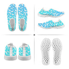 A four-panel product collage showing a pair of slip-on water shoes from multiple angles: top view, side views, and sole views. The shoes have a bright aqua and white shark pattern on the uppers with white perforated soles.