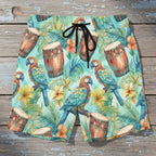 close up of tropical-themed shorts with parrots and drums  laying flat on a rustic nautical wood deck