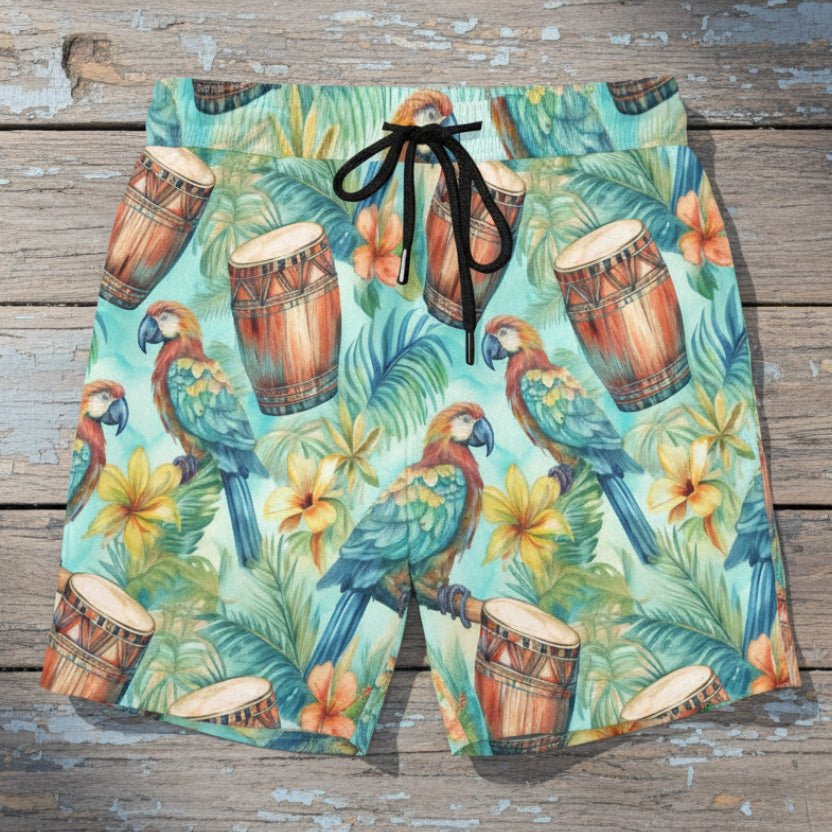 close up of tropical-themed shorts with parrots and drums  laying flat on a rustic nautical wood deck