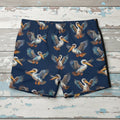 Navy swim shorts with pelican pattern on nautical wood background