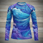 Blue and purple wave-patterned shirt on a wooden surface with coconuts and a cap.