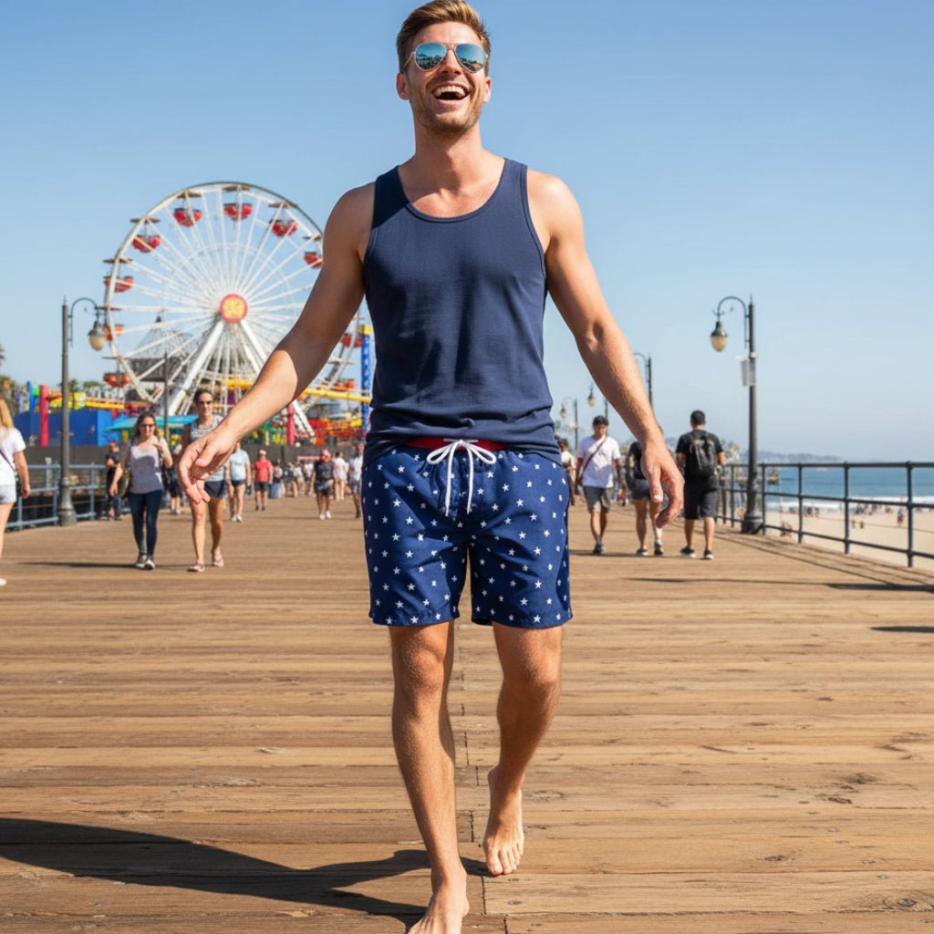 Dude wearing shorts, sunglasses and a navy blue tank top having a good time on Santa Monica Pier.
