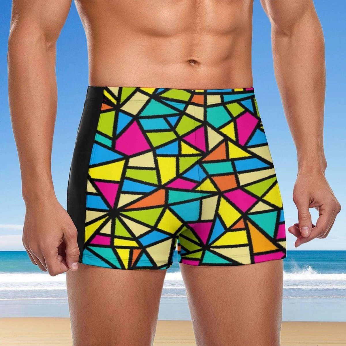 Person wearing colorful geometric patterned swim shorts with a beach background