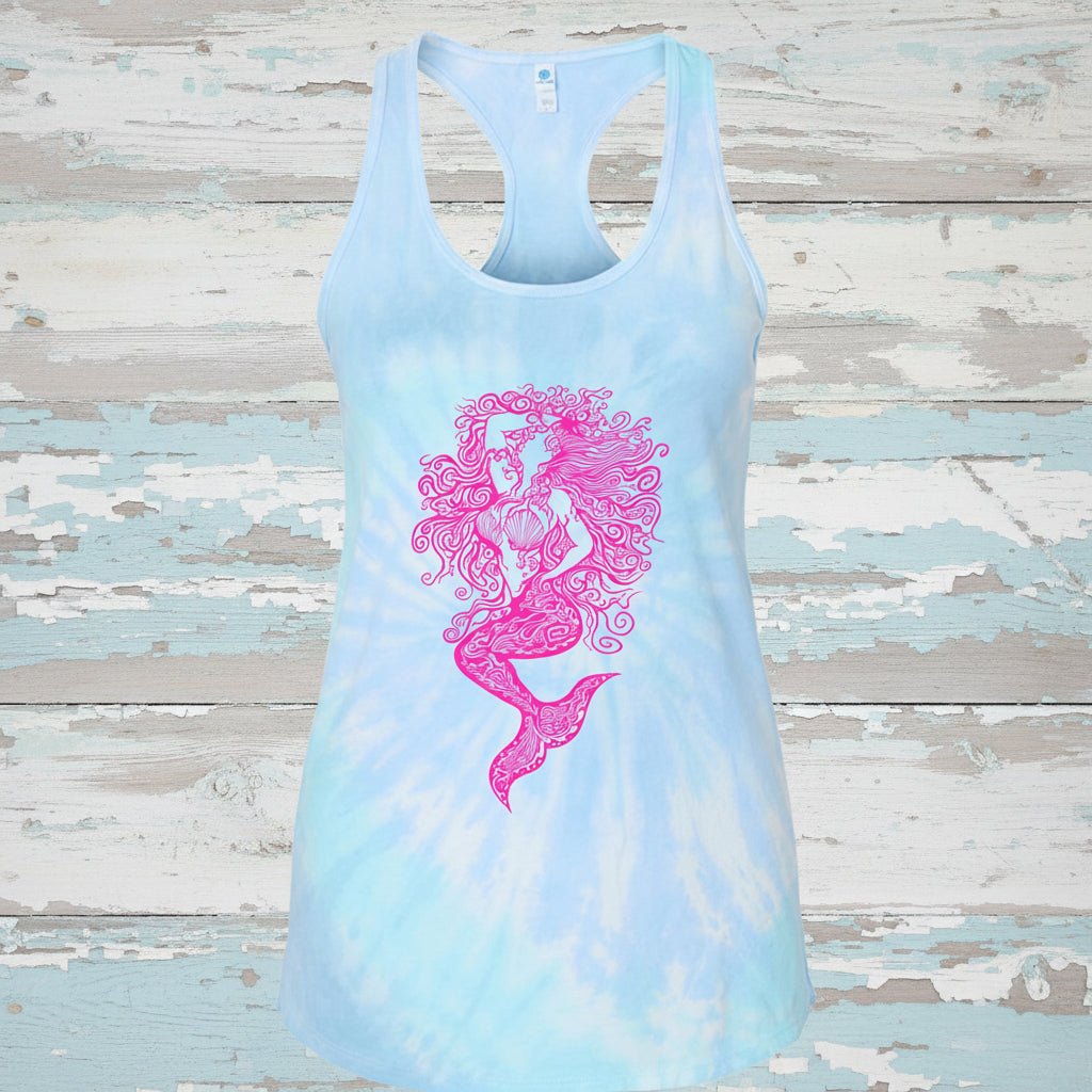A light blue and white lagoon blue tie-dye racerback tank top featuring a vibrant pink mermaid graphic printed on the front, displayed against a solid white background.