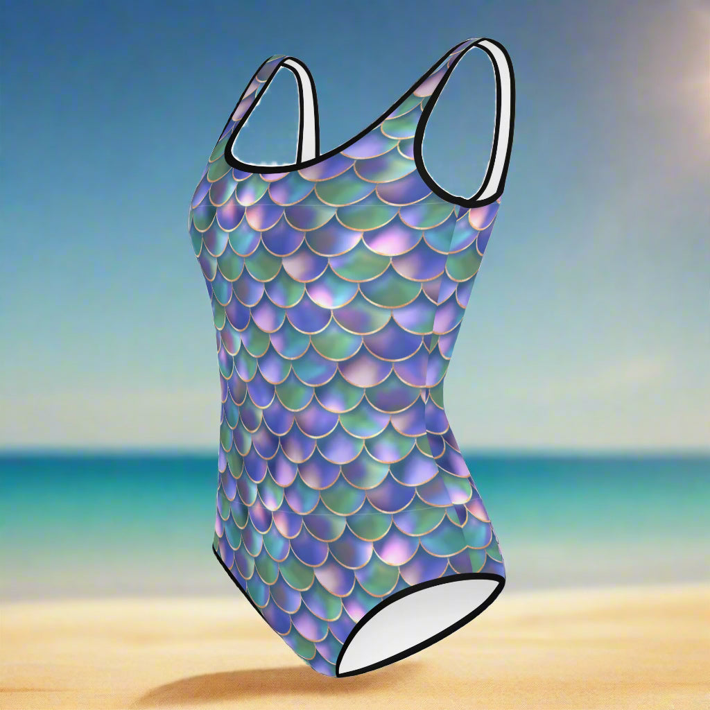 Mermaid scale-patterned swimsuit on a beach background