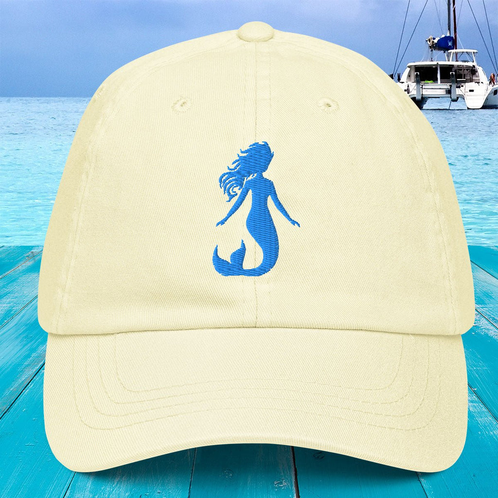 Beige cap with blue mermaid silhouette on a blue water background