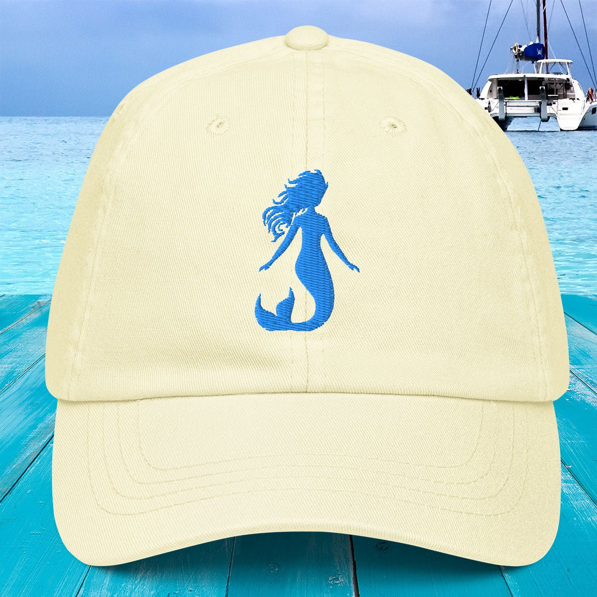 Beige cap with blue mermaid silhouette on a blue water background