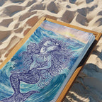 Zen Mermaid printed on a plush beach towel laying on a wooden beach chair in the sand