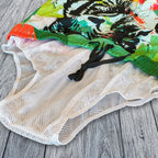 Colorful fish-themed fabric on a wooden surface with a mesh bag.