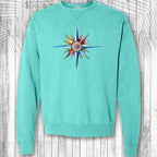 Turquoise sweatshirt with a colorful nautical compass design on a wooden background