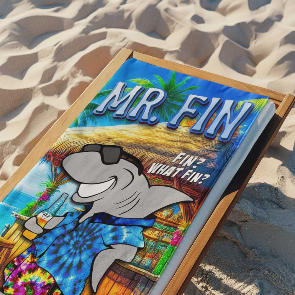 Beach towel featuring Mr. Fin laying on a wood lounge chair on the beach