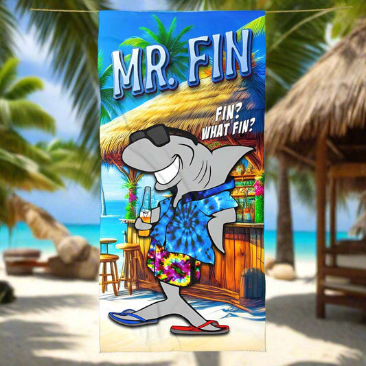 Mr Fin, a land shark character hanging out a tiki bar printed on this fun plush beach towel hanging on a line in a tropical paradise