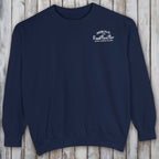 Navy blue sweatshirt with white text on a wooden surface