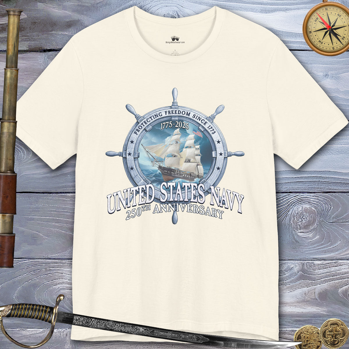 White t-shirt with United States Navy design on a wooden surface with a sword and compass.
