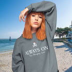 Person wearing a gray sweatshirt with text on a beach