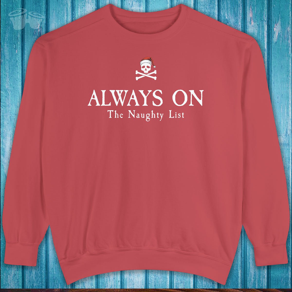 Red sweatshirt with text 'ALWAYS ON The Naughty List' on a blue wooden background