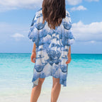 Person wearing a blue ship-themed cover-up on a beach