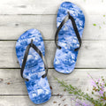 Blue flip-flops with nautical ship pattern on a wooden surface