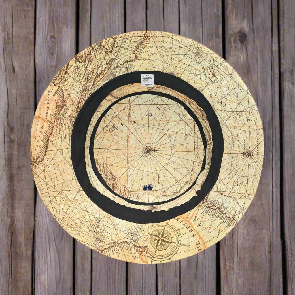 Vintage Nautical Chart Bucket Hat laying upside down on a rustic wood pier.
