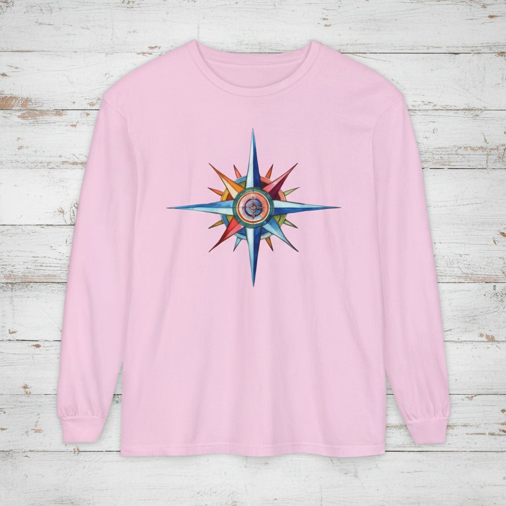 Pink long-sleeve shirt with a colorful star design on a wooden surface