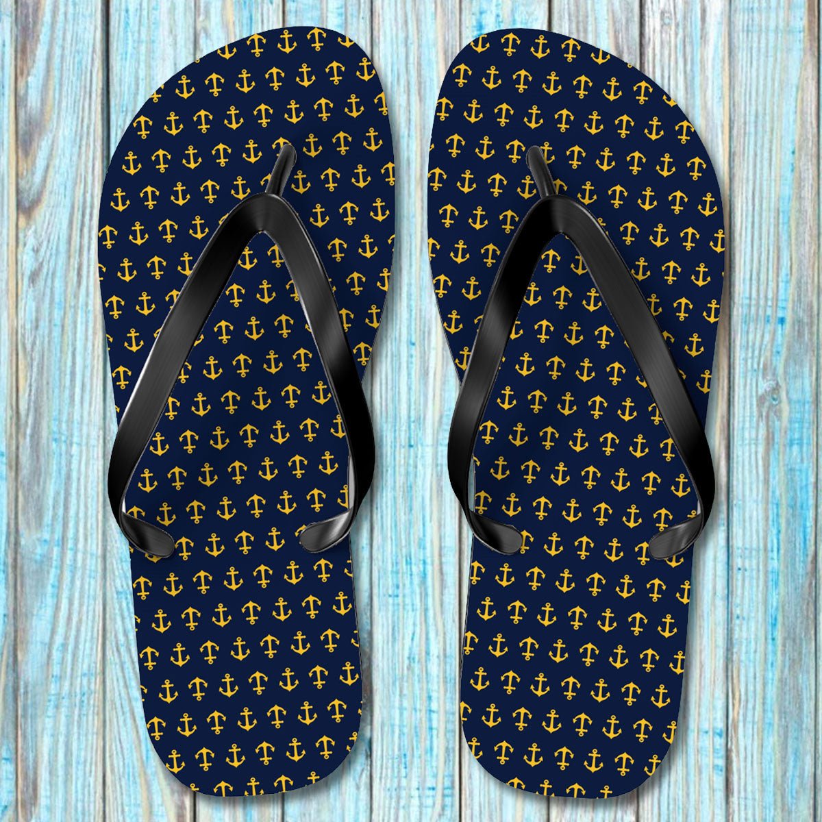 Pair of Navy Anchor Flip Flops with anchor pattern on a wooden surface