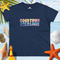 Good Times & Tan Lines women's beach lover t-shirt on a sandy beach background with seashells and tropical vibes.