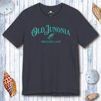 Navy blue t-shirt with 'Old Junonia Sheller's Club' text on a wooden surface with shells.