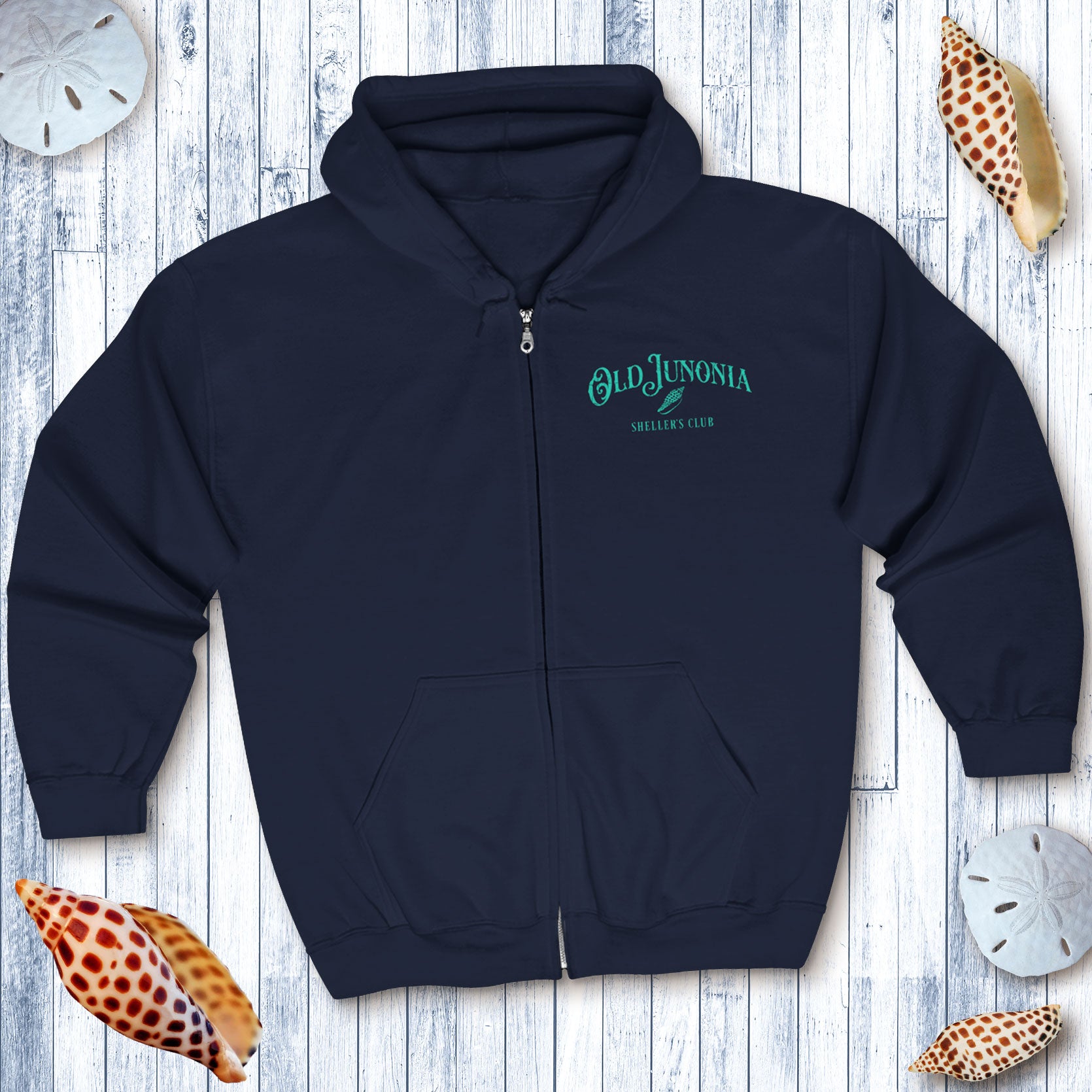 Navy blue hoodie with 'Old Junonia' logo on a wooden surface with seashells.