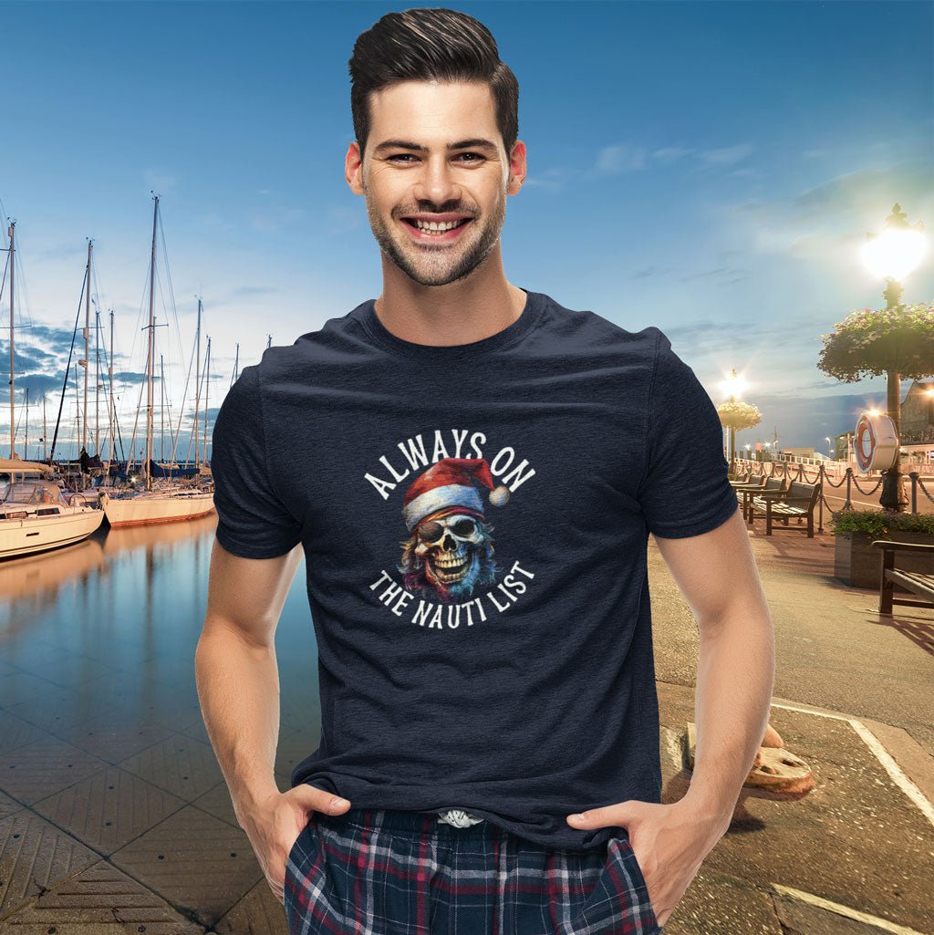 Man wearing a navy blue t-shirt with a graphic design by a marina.