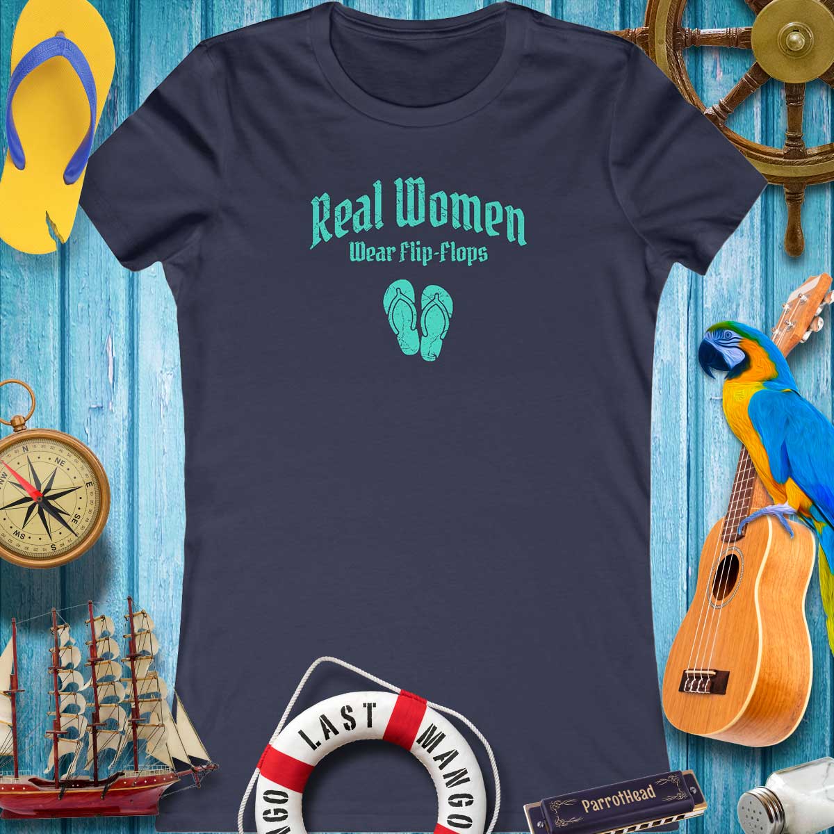 Ladies Bella Canvas Short Sleeve Tee on Rustic wood background surounded by ParrotHead icons; A blownout FlipFlop a antique compass, a parrot sitting on a ukulele