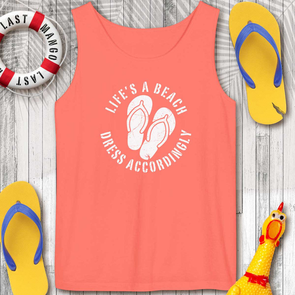 Neon Red-Orange tank top with 'Life's a Beach Dress Accordingly' text and flip-flops on a wooden surface.