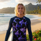 Surfer wearing a long-sleeve rash guard with purple fish skeleton pattern on a North Shore Oahu 