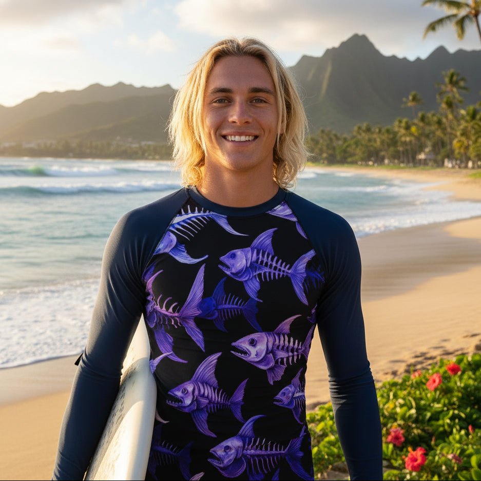 Surfer wearing a long-sleeve rash guard with purple fish skeleton pattern on a North Shore Oahu 