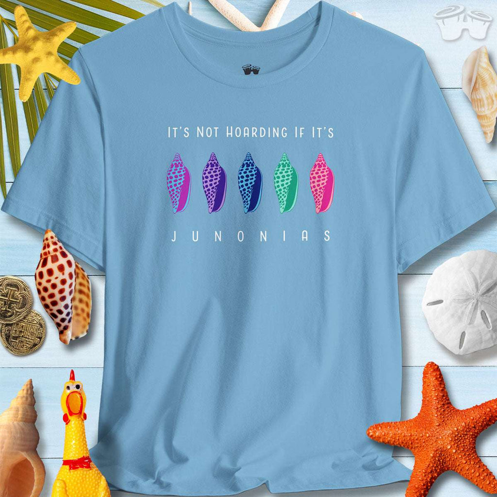 Colorful Junonia T-shirt on a beach backdrop with seashells, ideal for summer and beach lovers.