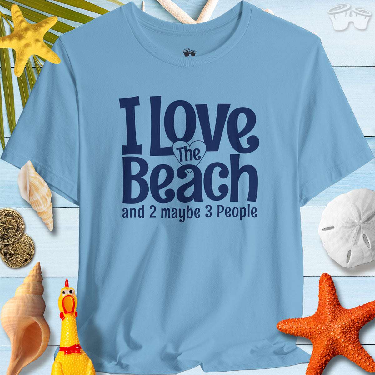 Light blue t-shirt with 'I Love The Beach and 2 maybe 3 People' slogan, perfect for beach lovers and casual outings.