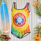 Teen Sea Turtle Tie Dye Swimwear with cool sea turtle silhouette on classic tie dye floating in front of a rustic wood wall surrounded by surfing icons and beach favorites.