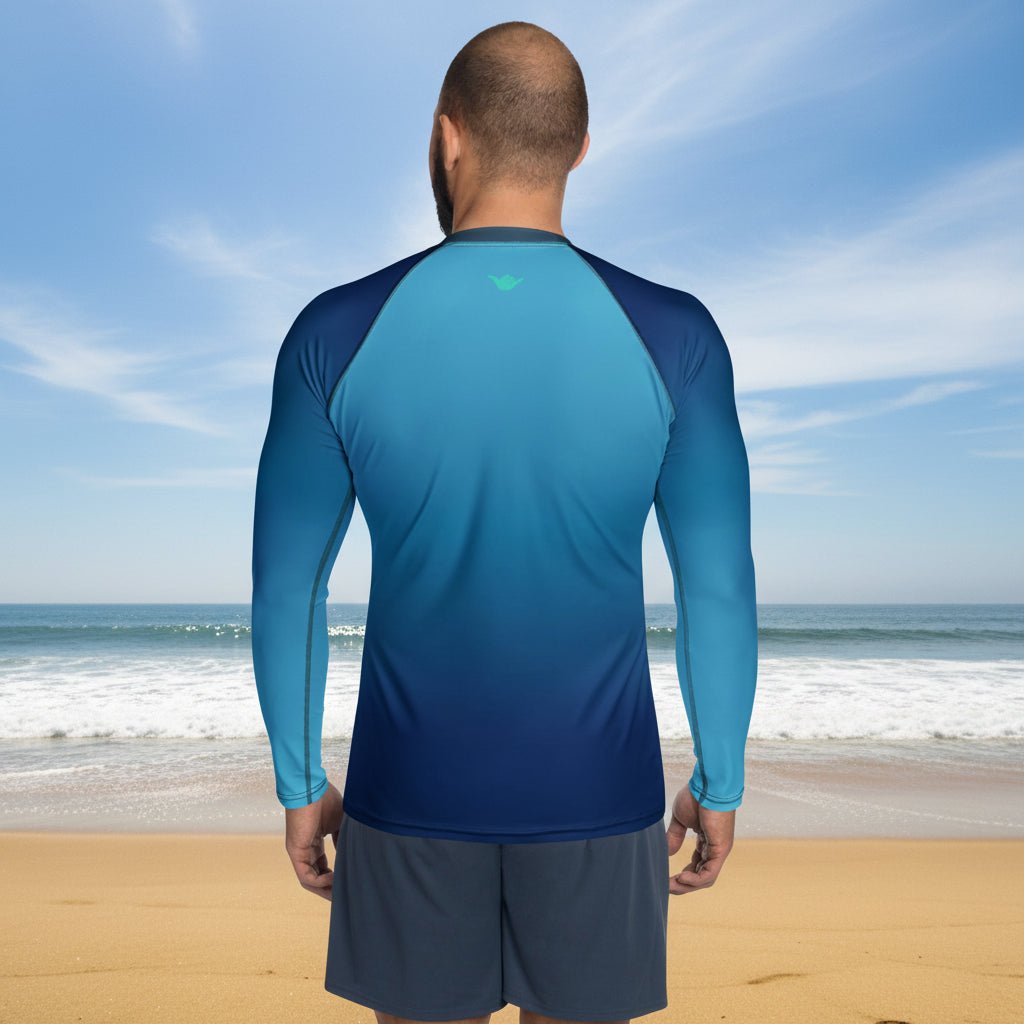 Man wearing a blue athletic shirt and gray shorts on Oceanside Beach