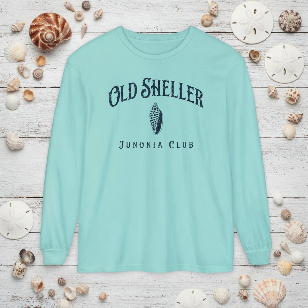 Light blue long-sleeve shirt with 'Old Sheller Junonia Club' text and shell graphic on a white background