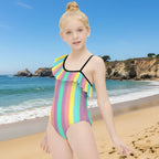 Young girl wearing a colorful striped swimsuit on La Jolla Beach