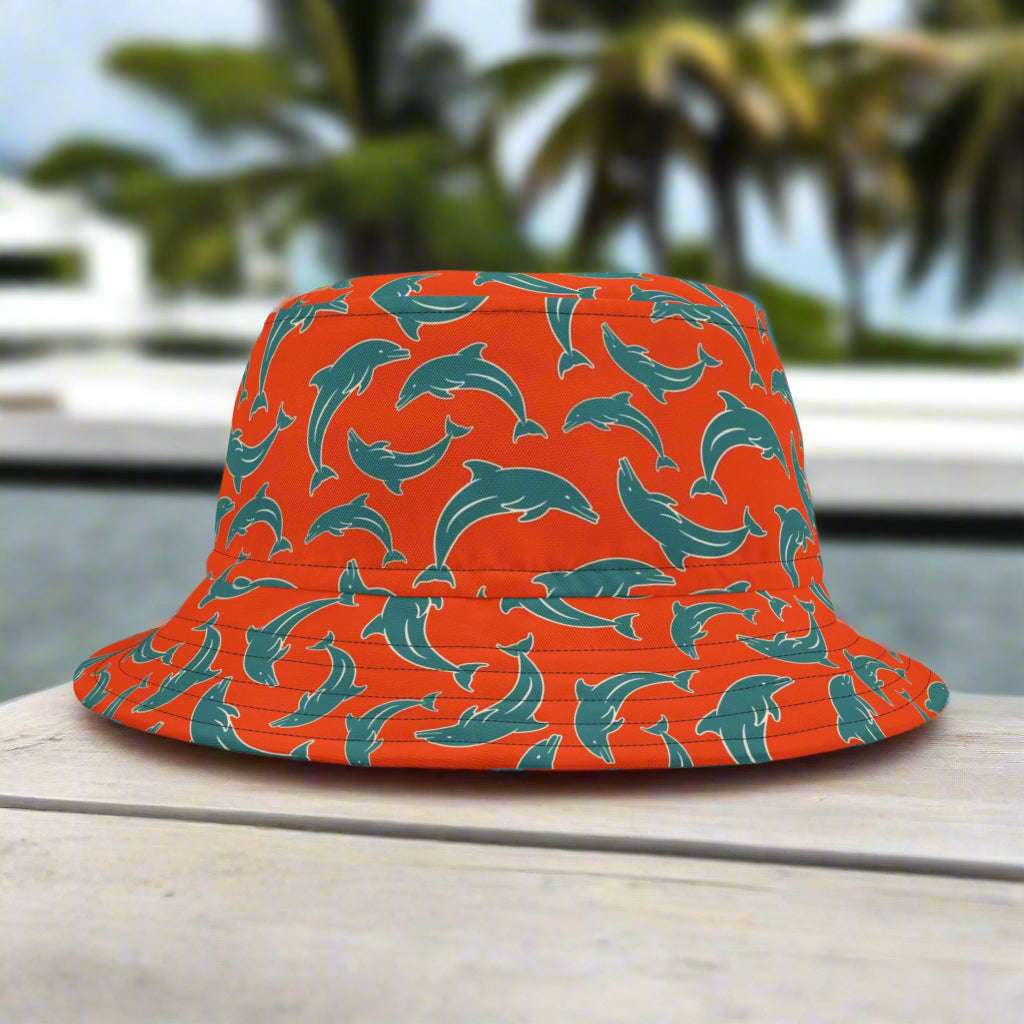 Bucket hat in Miami Dolphin Team Colors sitting on park bench in south beach
