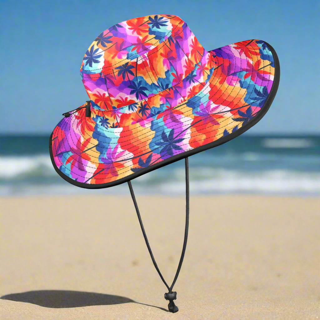 Colorful bucket hat with palm tree pattern on a beach background