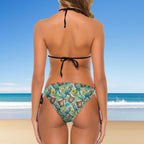 Woman wearing a colorful bikini with a beach background
